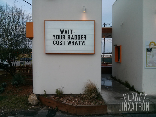 sign on juice store says wait, your badger cost what?